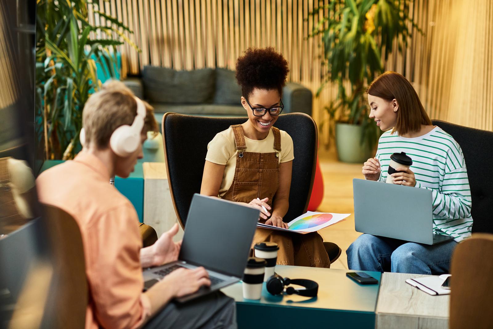 Three founders working together around a table in a coworking space